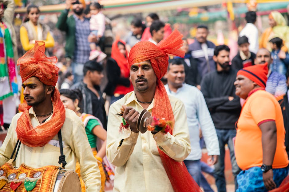 Vibrant street festival in India featuring traditional musicians in colorful attire.